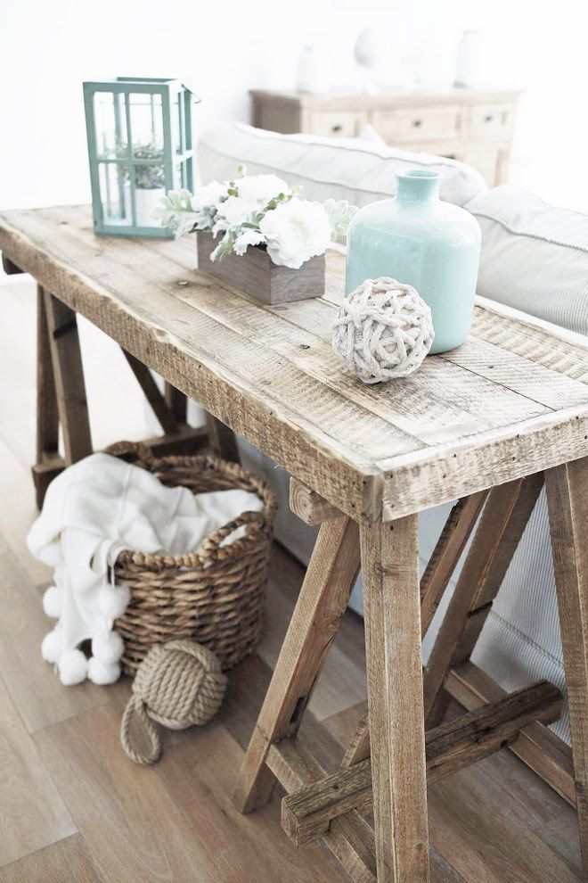A reclaimed wood table stacked with home decor to give that lake house feeling