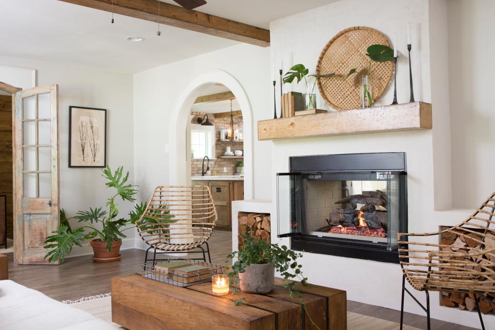 A fireplace, a reclaimed beam and mantel mixed with doors that are bespoke and furniture that has stories to tell create a perfect lake home even when the nights are a little chilly