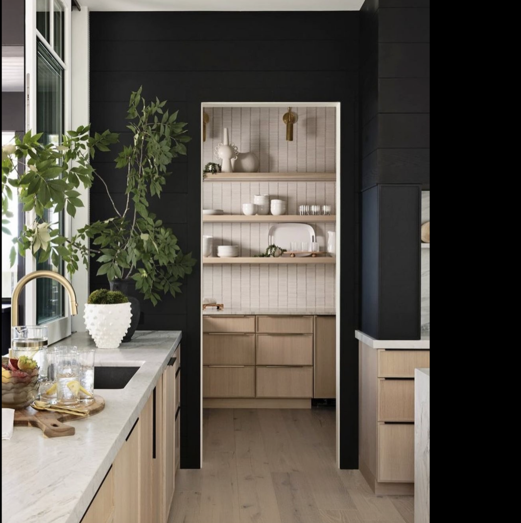 The bold contrast of black to white is stunning and draws you in to the space. Loving the mix of black, white and neutral wood.