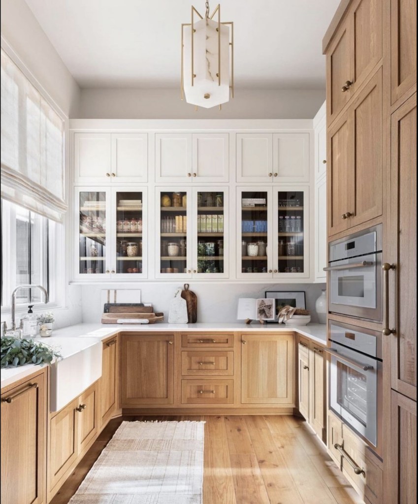  a gorgeous scullery with white and neutral wood cabinets 