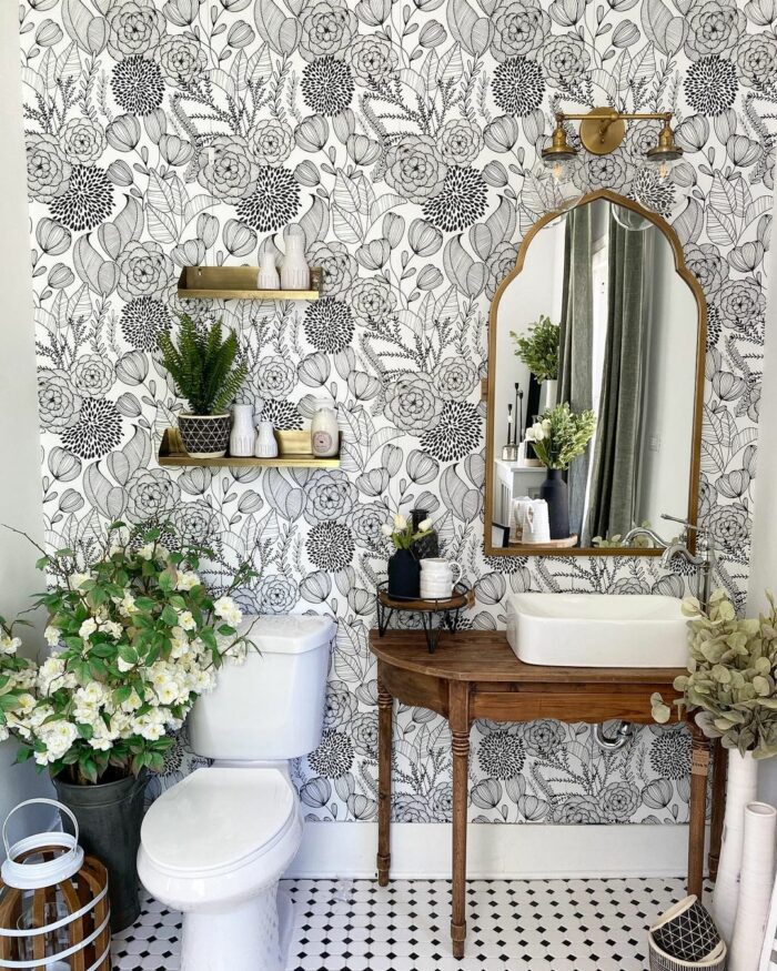 Powder room featuring bold, floral wallpaper with gold accents and warm wood details . Custom home builder and interior designer Charlotte interior design